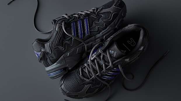 View of Bad Bunny's black and blue adidas sneakers.